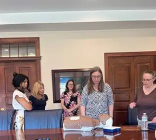CPR training session for staff in a conference room